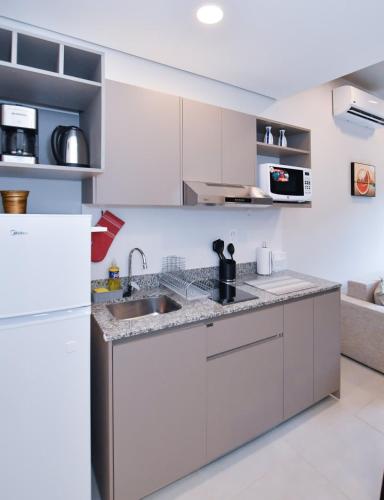 a kitchen with white cabinets and a sink at Modern One-Bedroom for Work and Relax in Fernando de la Mora
