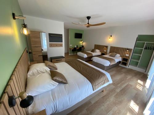 a bedroom with two beds and a living room at Nouvel Hotel in Lons-le-Saunier