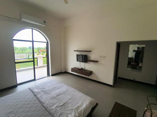 a bedroom with a bed and a large mirror at The Emerald Palace in Sehore