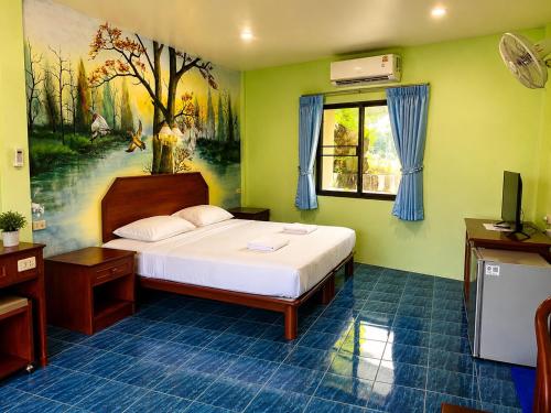 a bedroom with a bed and a painting on the wall at Baan Mon Hill in Patong Beach