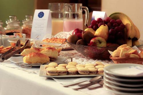a table with a bunch of different types of food at Hotel del Virrey in Luján