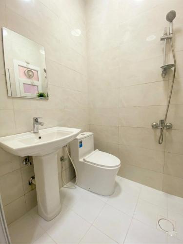 a white bathroom with a sink and a toilet at RED algarbeia in Salalah