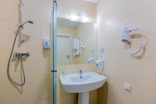 a bathroom with a sink and a shower at PracticOtel Kyiv in Kyiv