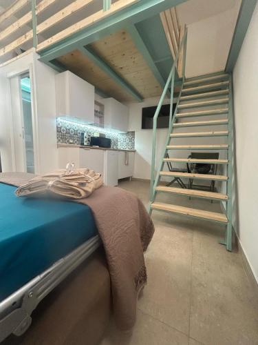 a room with a bed and a staircase in the background at Ciemme Apartments in Castellammare di Stabia