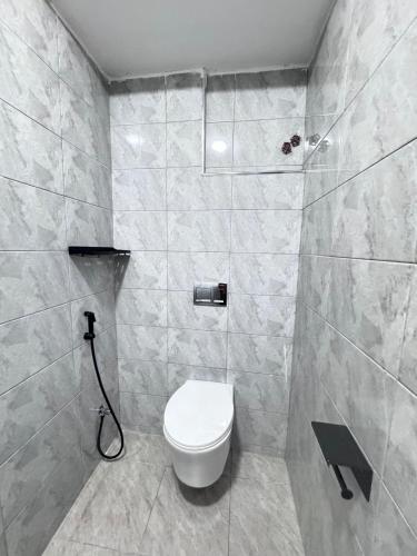 a bathroom with a toilet and a shower at Riverview greenstar cozy homes in Kisii