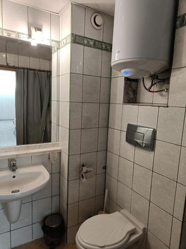 a small bathroom with a toilet and a sink at Sol e Mar in Sunny Beach