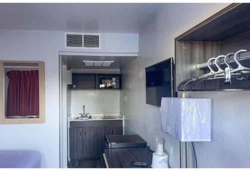 a small kitchen with a sink and a refrigerator at Studio 6 Fort Collins CO in Fort Collins