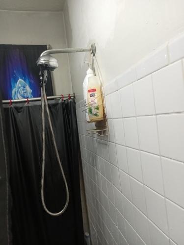 a shower in a bathroom with a black shower curtain at Anderson home services in Woodlawn