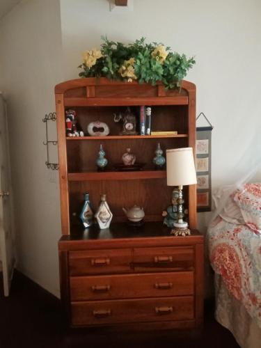 a dresser with a lamp on top of it at WELCOME TO My COTTAGE in Sunland