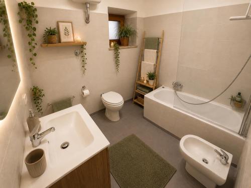 a bathroom with a sink and a toilet and a tub at Il Focolare in Subiaco