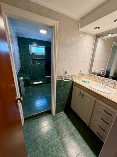 a bathroom with a shower and a sink and a mirror at Ivamar Hotel & Apart in Ostende