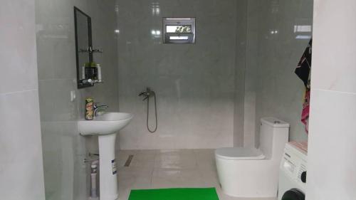 a white bathroom with a sink and a toilet at Guest House FAIZ homestay in Panjakent