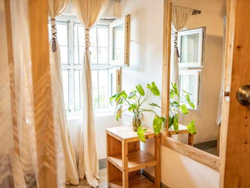 a room with a window and a table with a mirror at Old Stone Boutique Lodge in Bagamoyo