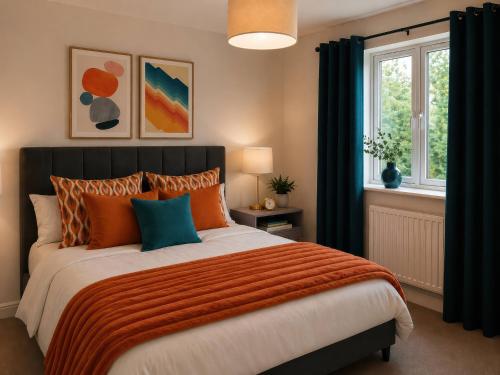 ein Schlafzimmer mit einem Bett mit orangefarbenen und blauen Kissen in der Unterkunft Haregate House in Leek