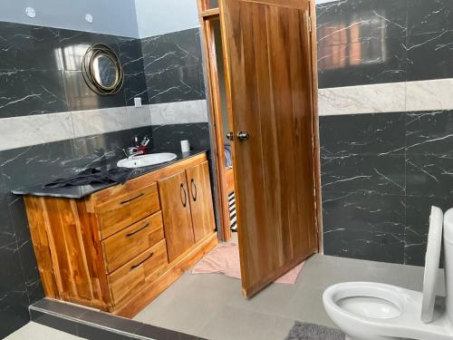 a bathroom with a sink and a toilet at Buye Holiday House in Mwanza