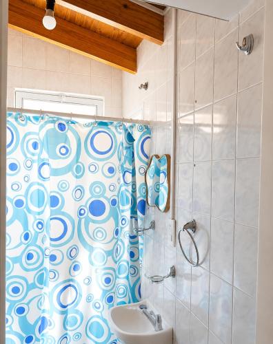 a bathroom with a shower curtain and a sink at Casa RAU-JO in Guaymallen
