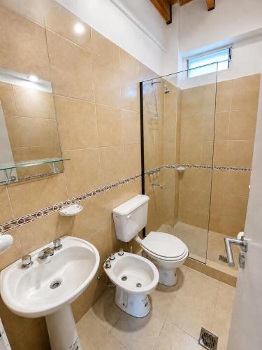 a bathroom with a toilet and a sink and a shower at Departamentos Centro in San Juan