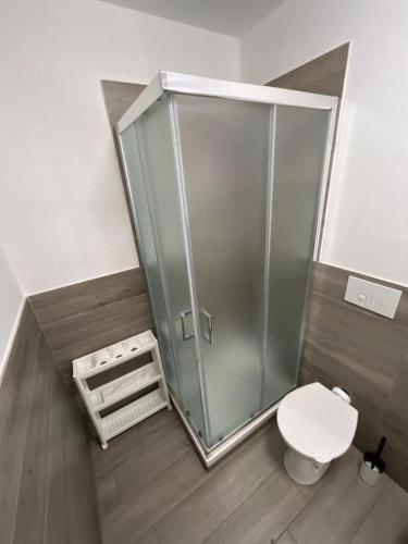 a bathroom with a toilet and a glass shower at Nova Stay in Rome