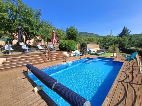 a swimming pool on a wooden deck next to at " LE CHABASSOLE " CHAMBRES D'HÔTES - GORGES du VERDON in Aiguines