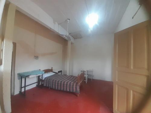 a room with a bed and a table in it at Tata Róga in Asunción