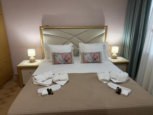 a bedroom with a bed with towels on it at Markella STONE & LIGHT Skoutari-Mani in Skoutari