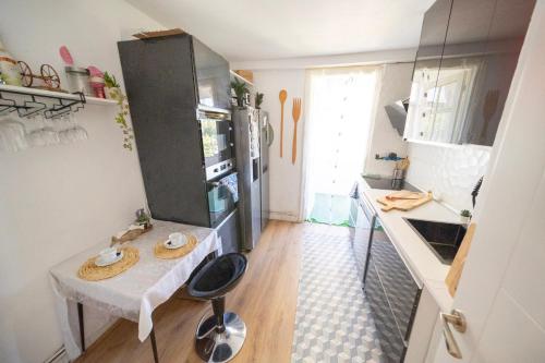 a small kitchen with a small table in a kitchen at Casa Jardin Huesca Ciudad in Huesca