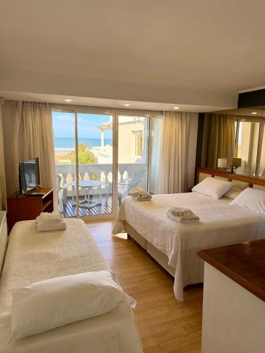 a hotel room with two beds and a balcony at Ivamar Hotel & Apart in Ostende