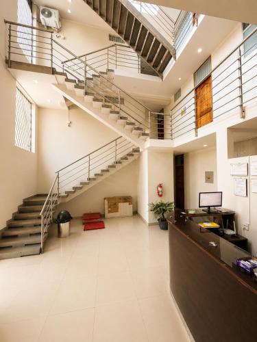 an office with a staircase in a building at La Posada Del Pajarito in Yurimaguas