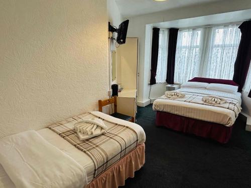 a hotel room with two beds and a window at Ride Side Delton Hotel in Blackpool
