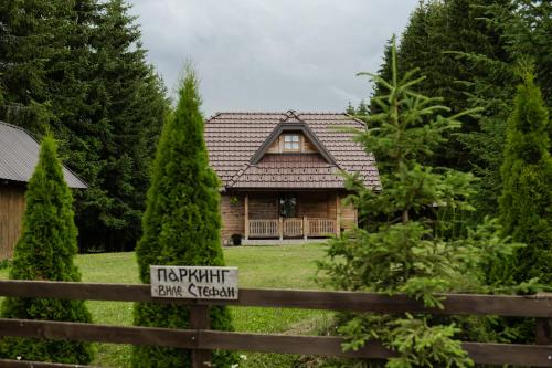 a house with a sign on a fence at Vile Stefan in Zaovine