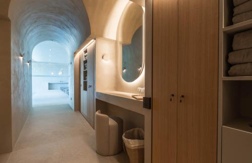 a bathroom with a sink and a mirror at La Villa des Vignes in Saint-Émilion