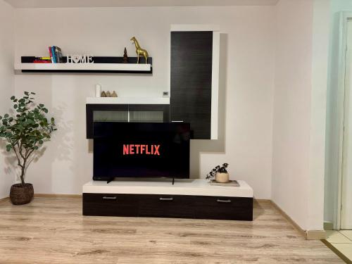 a living room with a flat screen tv on a cabinet at Apartament Central Pietonalul Unirii in Botoşani