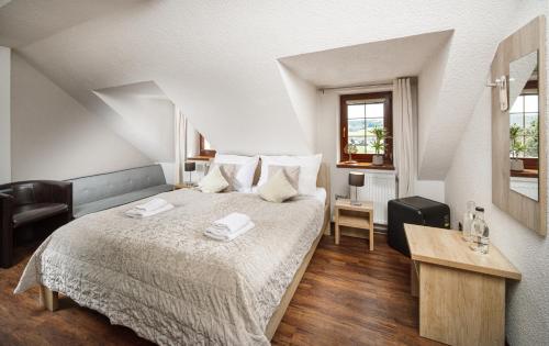 a bedroom with a bed with two towels on it at Wellness Pension AniLife in Číměř
