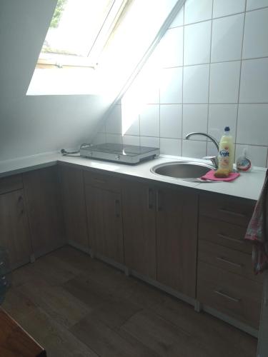 a kitchen with a sink and a mirror at KAM-TECH Krzysztof Kamiński in Krzywy Róg