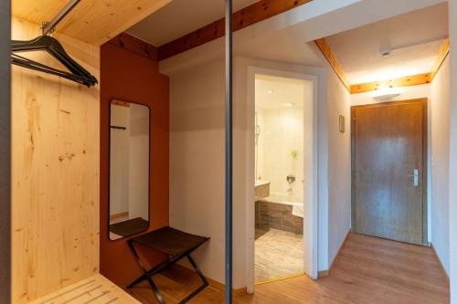 a bathroom with a glass door and a tub at Hotel Bären in St. Moritz