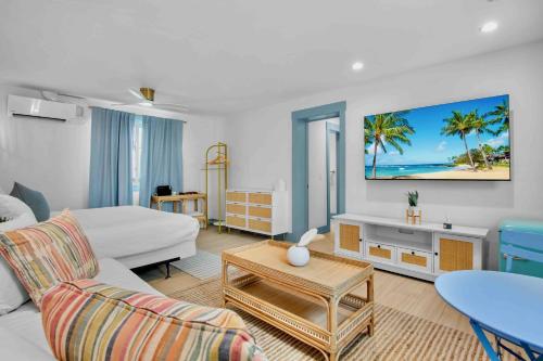 a living room with a bed a couch and a table at Haley's at Anna Maria Island Inn in Holmes Beach