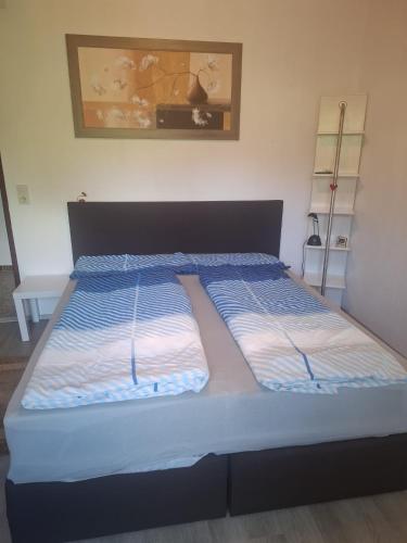 a bed with two pillows on it in a room at Haus Steiner in Kleblach