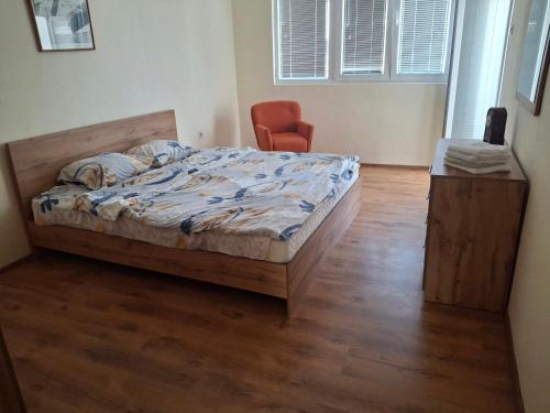 a bedroom with a bed and a chair at Apartment V in Ohrid