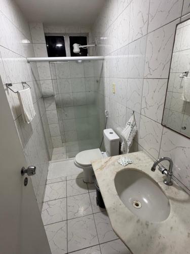 a bathroom with a sink and a toilet at Hotel Coqueiral in Recife