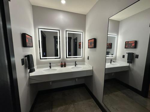 a bathroom with three sinks and three mirrors at A12 Gallant Fox B02 Suite in Louisville