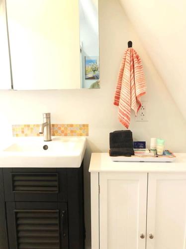 a bathroom with a sink and a mirror at Sunset n Chill in Sunset Beach