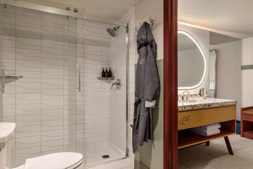 a bathroom with a shower and a toilet and a sink at Outbound Sedona in Sedona