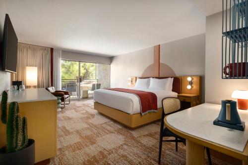 a hotel room with a bed and a desk at Outbound Sedona in Sedona