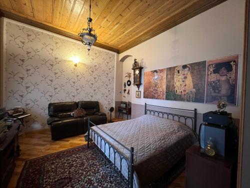 a bedroom with a bed and a couch at Gyumri Heritage House in Gyumri