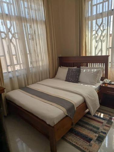 a bedroom with a large bed with pillows on it at KC Executive Lodge in Kikuyu