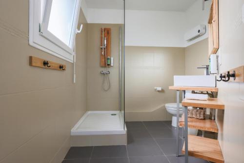 a bathroom with a shower and a toilet at Hôtel La Baïne in Capbreton
