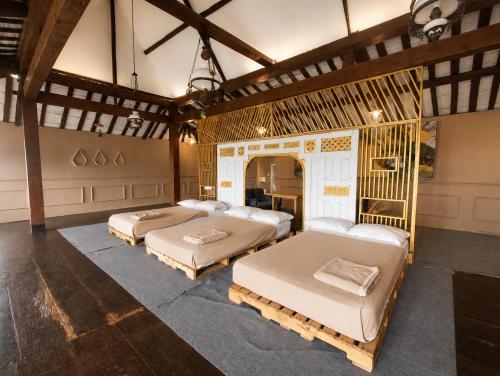 a room with three beds in it at Dulang Resort & Resto in Bongkar 2