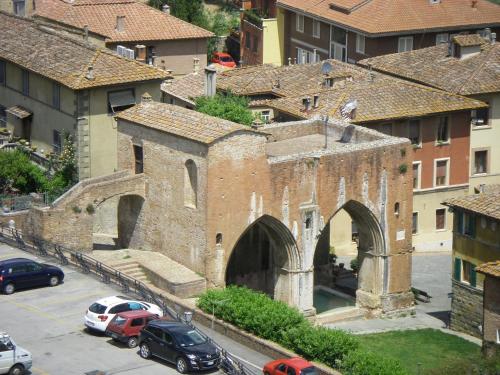 an old brick building with an arch in a city at Albergo Cannon d'Oro in Siena
