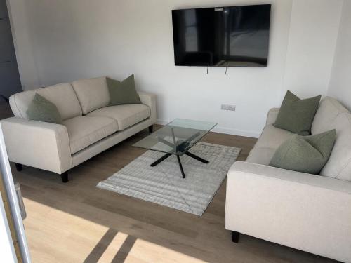 a living room with two couches and a coffee table at Dalhousie Residences in Carnoustie