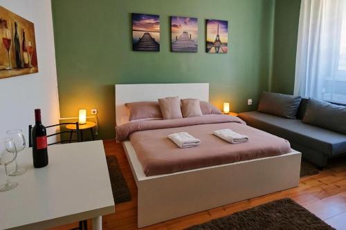 a bedroom with a large bed and a couch at Zöld Sziget Üdülőház in Egerszalók
